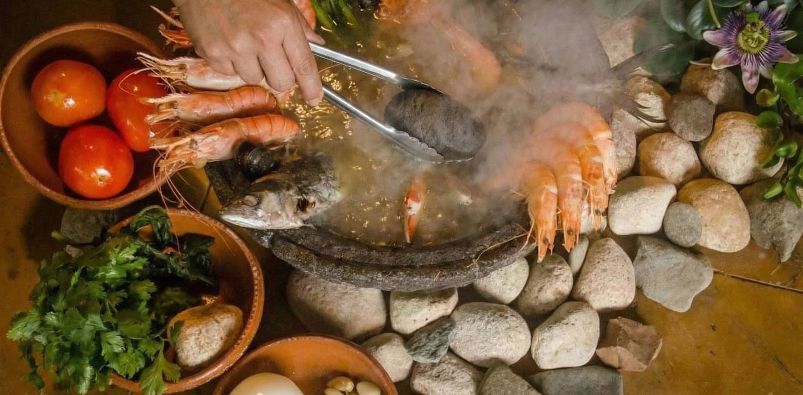 A large Oaxacan tlayuda topped with cheese, avocado, and grilled meat on a rustic plate.