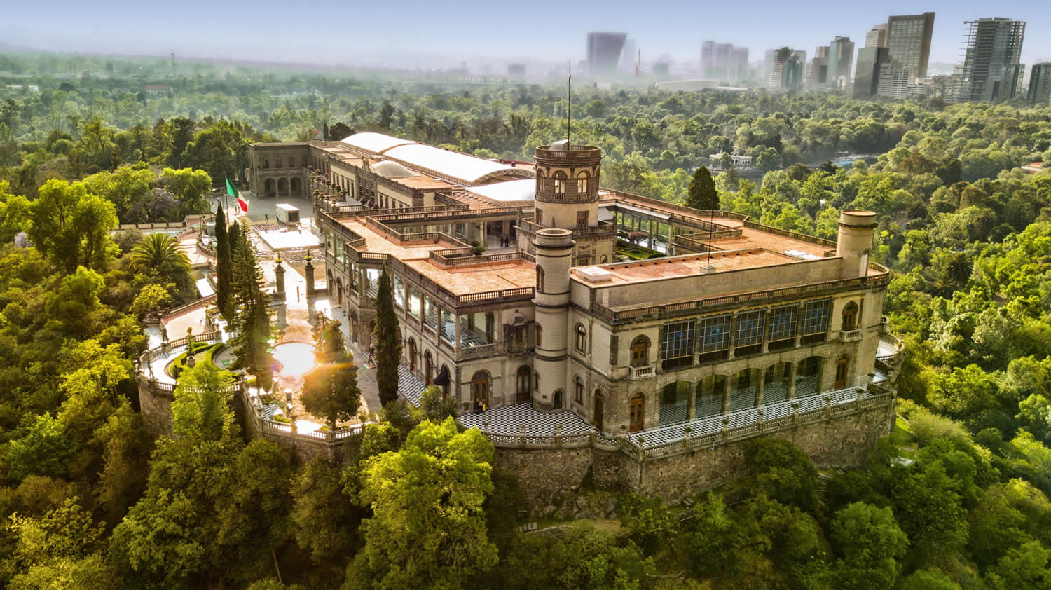 Chapultepec Castle perched on a wooded hill overlooking Mexico City with historic stone walls and panoramic city views